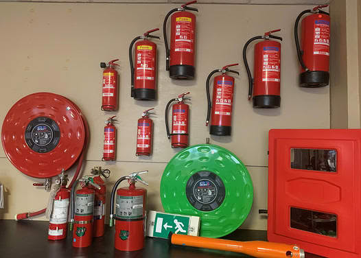 Wall of fire extinguishers serviced by Cattis NV